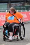 Woman in a wheelchair taking part in a race